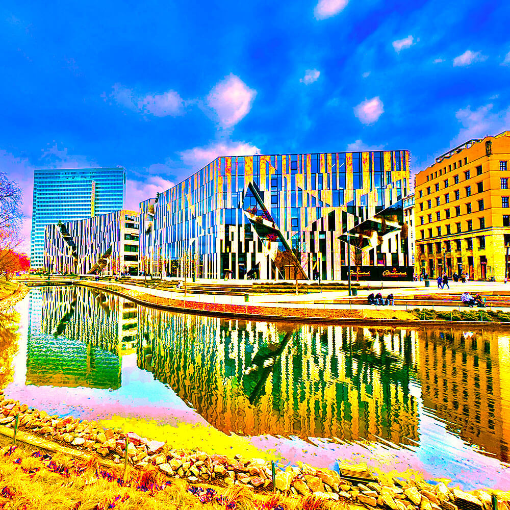 Popart-Bild vom Kö-Bogen in Düsseldorf. Die knalligen Farben reichen von leuchtendem blau über rosa und türkis bis hin zu einem gelb-orange.