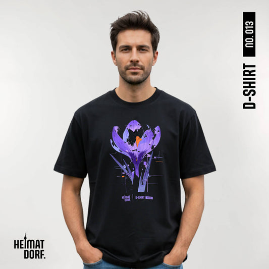 Mann trägt schwarzes Düsseldorf T-Shirt mit einem abstrakten Krokus aufgedruckt. Das T-Shirt ist die No. 013 der Düsseldorfer D-Shirt Kollektion.